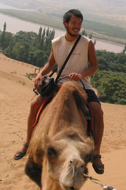Kevin mounting a camel on Ice Mountain near Songpan, China