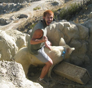 Kevin mounting a pig in moon valley near La Paz, Bolivia